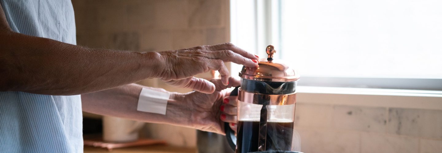 woman pouring herself coffee with Mary's Transdermal Patch on wood countertop