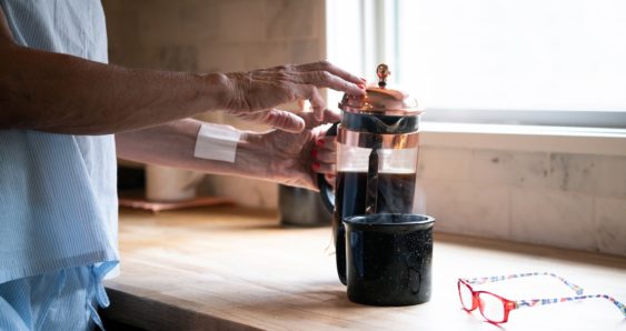 woman pouring herself coffee with Mary's Transdermal Patch on wood countertop