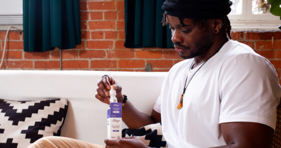 Man holding herbal tincture bottle indoors