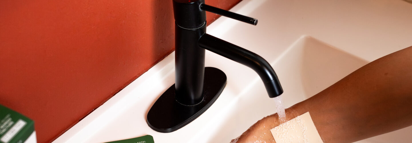 Applying transdermal patch near bathroom sink