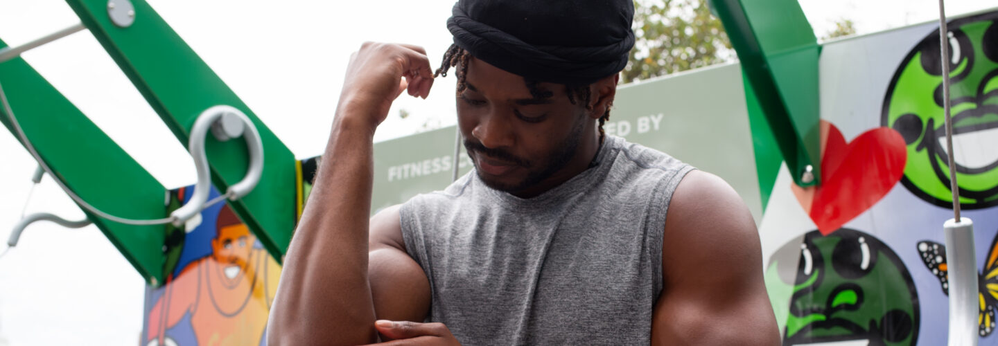 Man applying cream at outdoor gym
