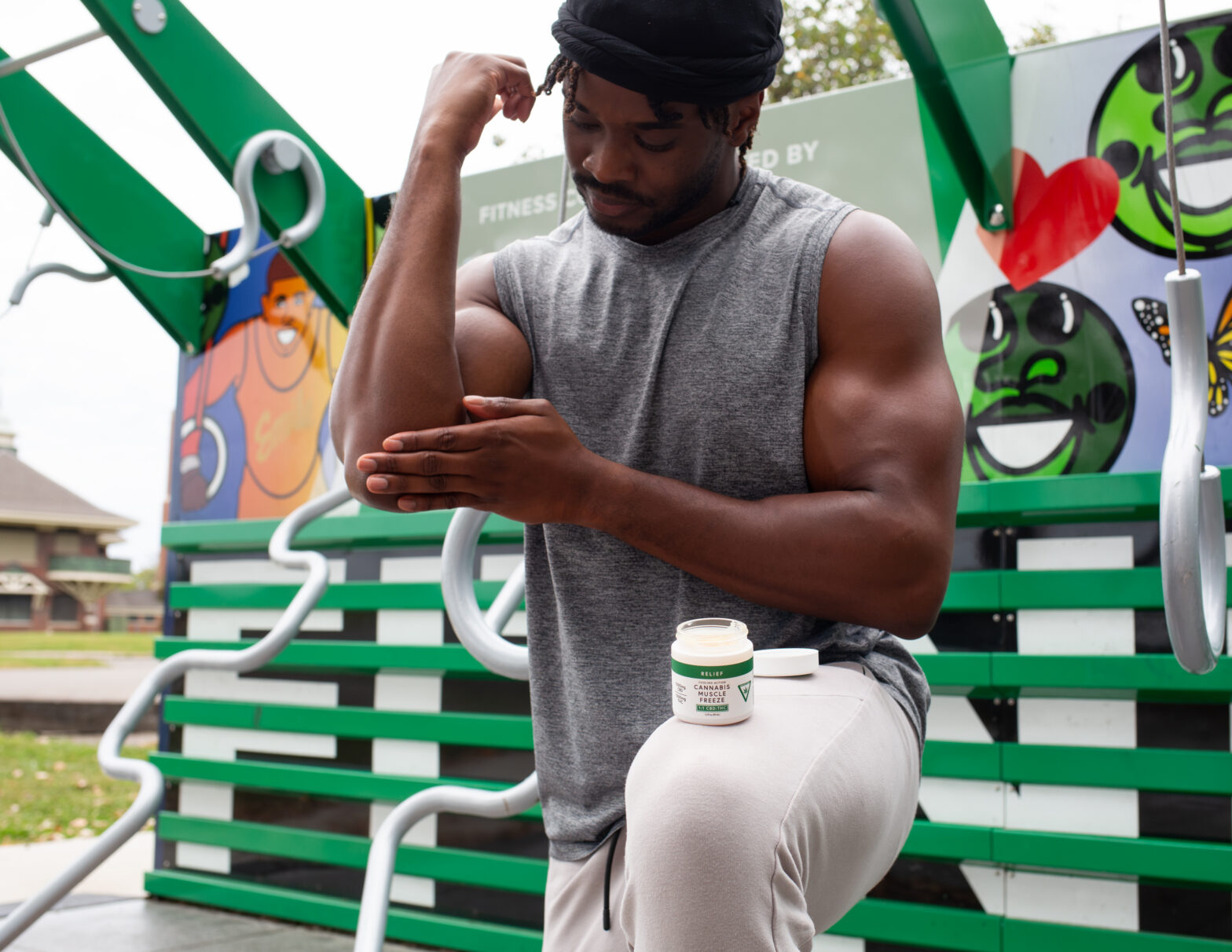 Man applying cream at outdoor gym