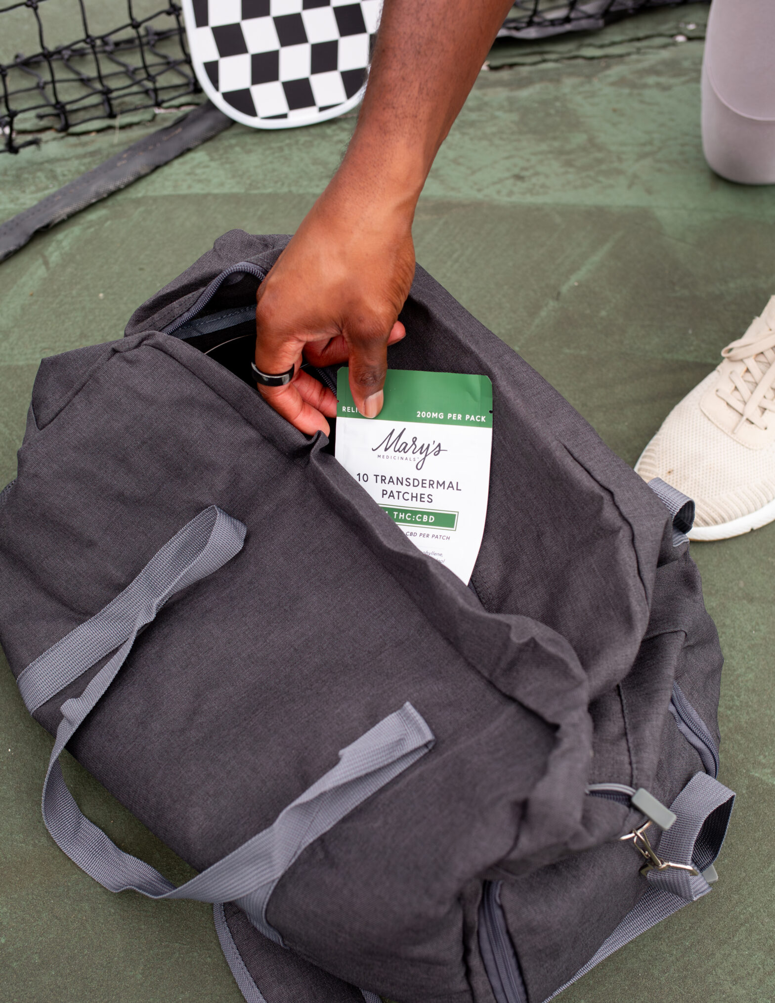 Person retrieving patch from black gym bag