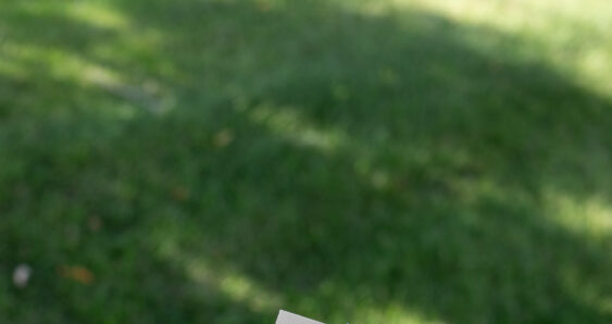 Hand cutting paper with purple scissors