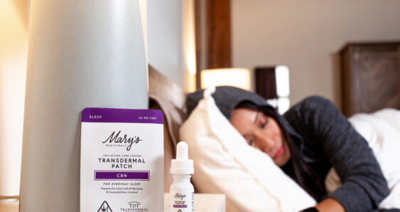 Woman sleeping with CBD products nearby