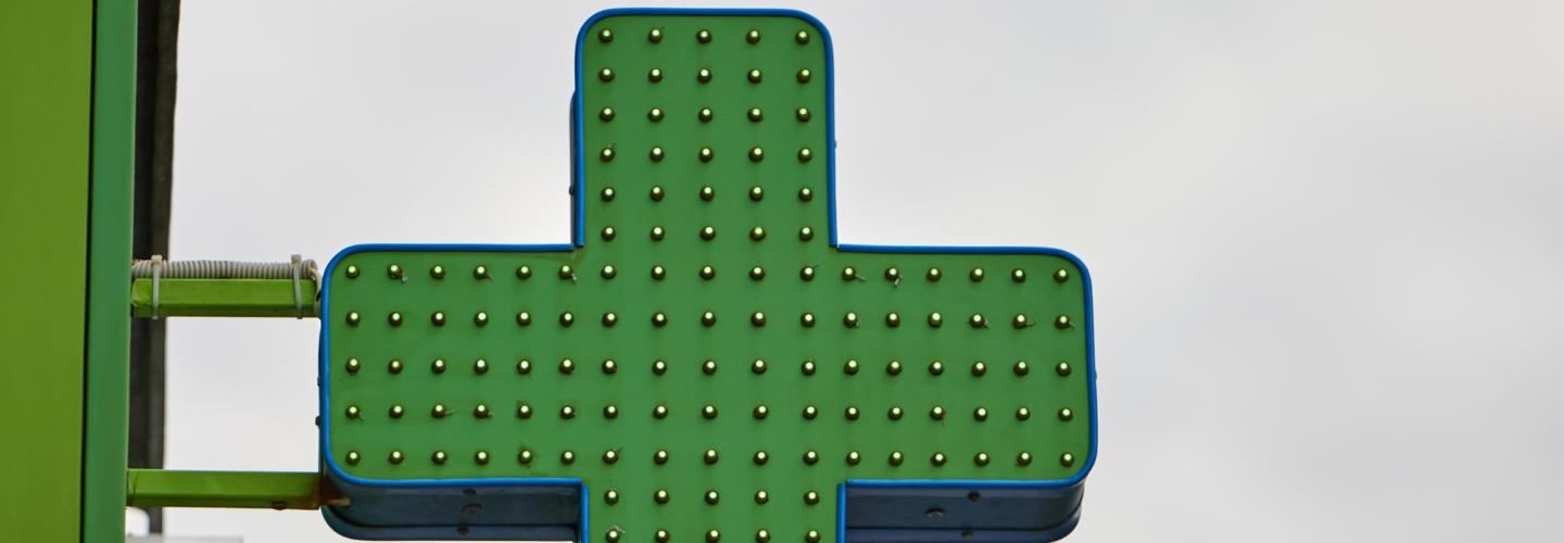 Green pharmacy cross sign with LEDs