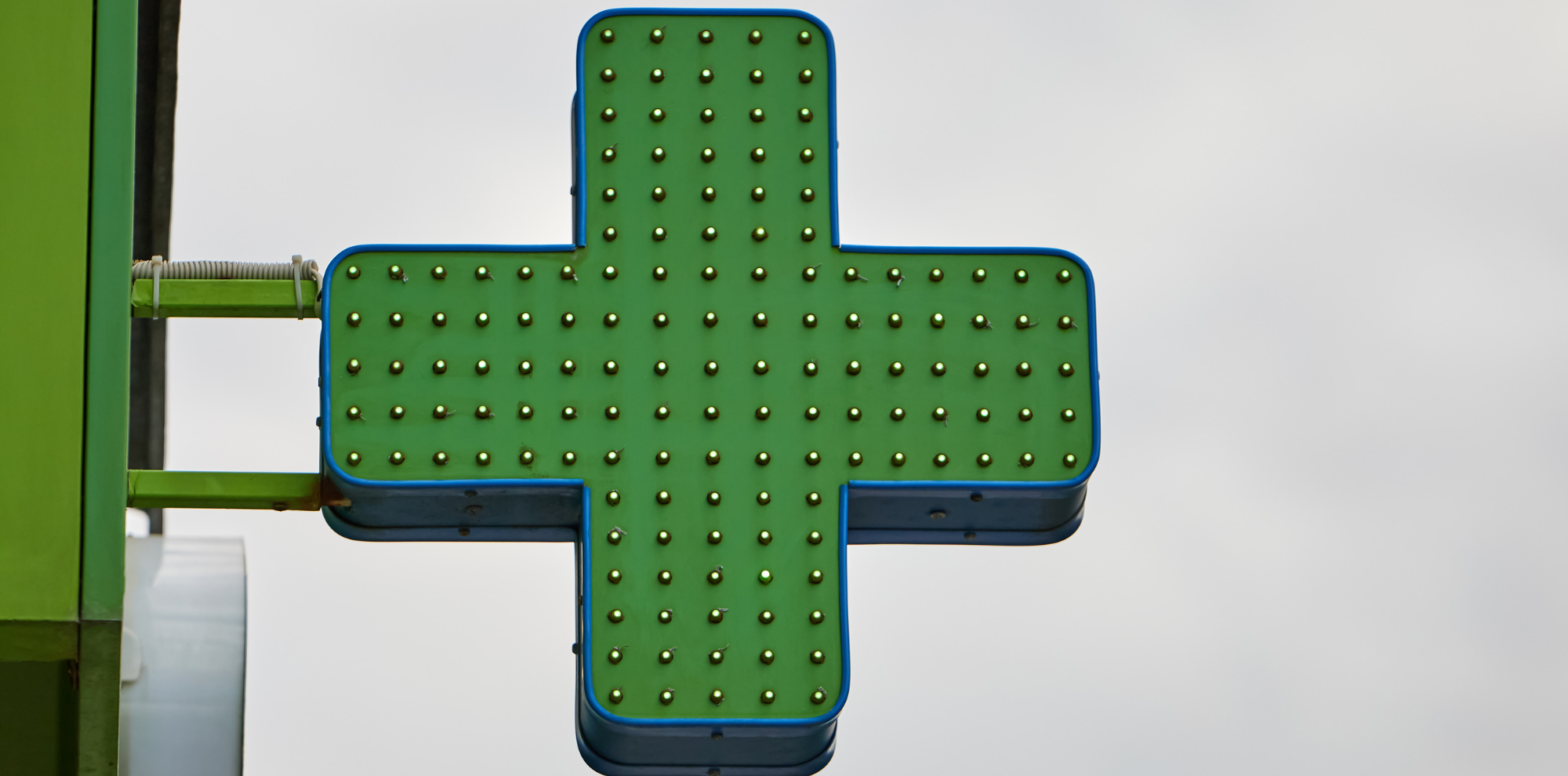 Green pharmacy cross sign with LEDs