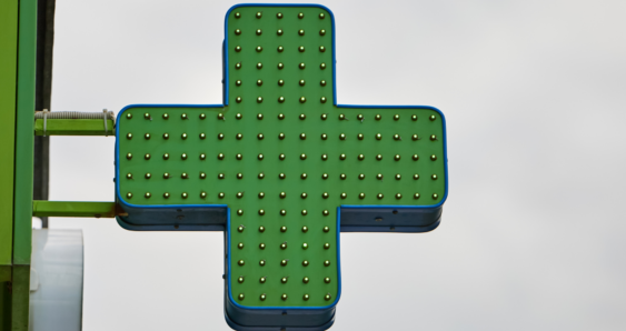 Green pharmacy cross sign with LEDs