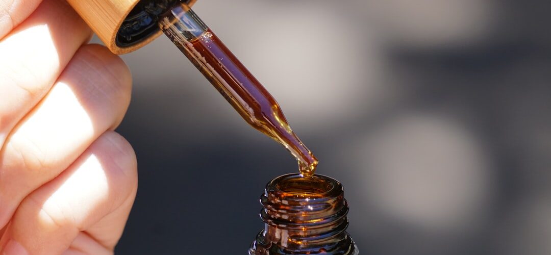 CBD oil dropper bottle in hand