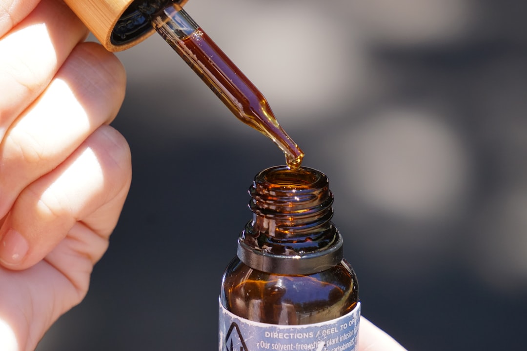 CBD oil dropper bottle in hand