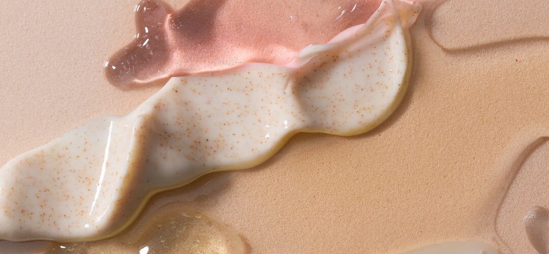 Skincare product textures on beige background