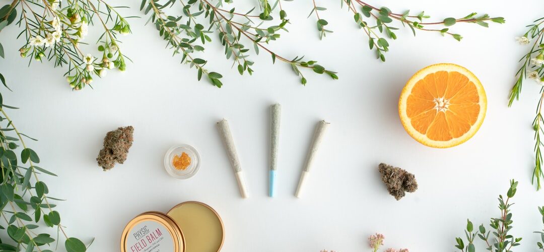 Cannabis products, balm, orange halves, flowers