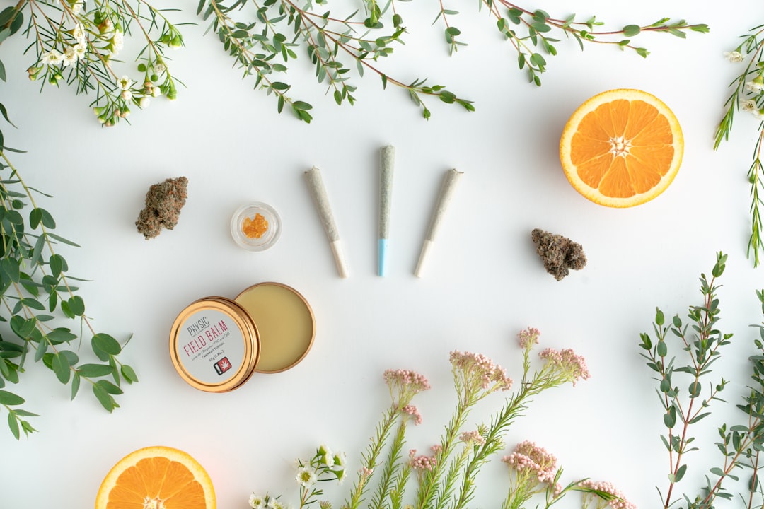 Cannabis products, balm, orange halves, flowers