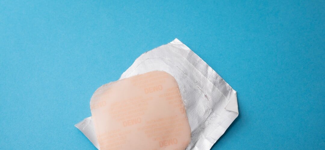 Square bandage on foil wrapper blue background