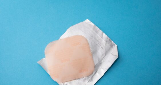 Square bandage on foil wrapper blue background