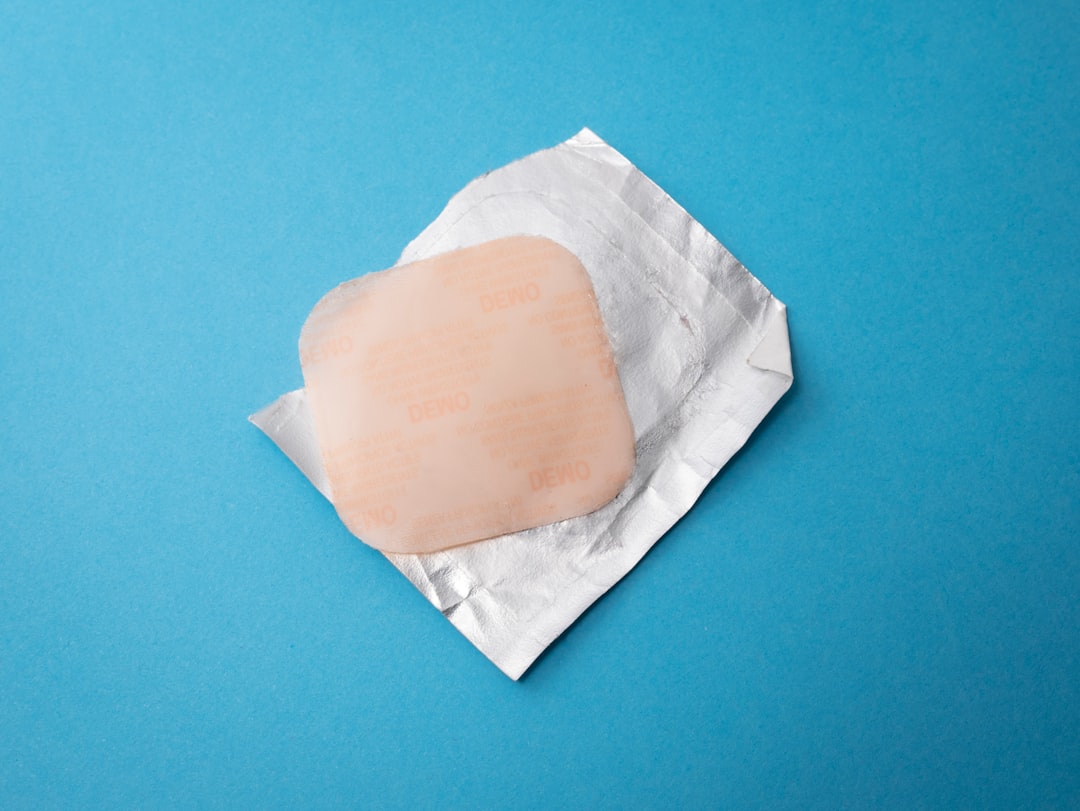 Square bandage on foil wrapper blue background