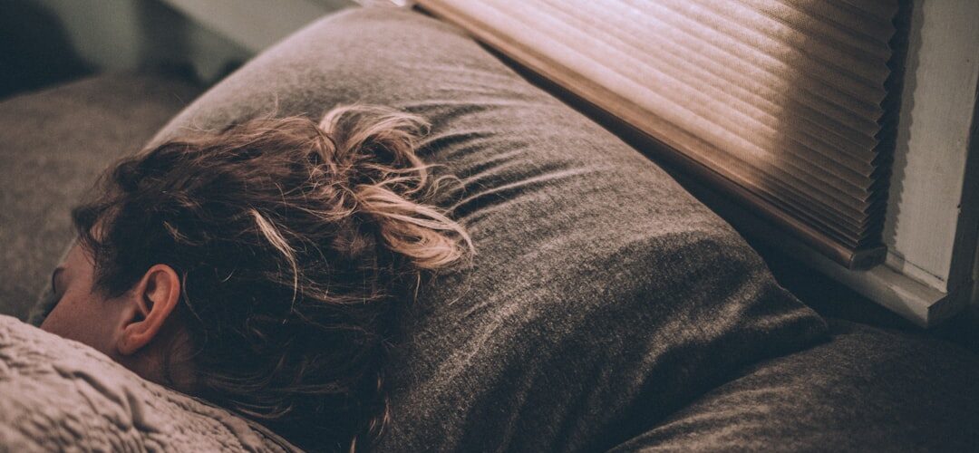 Woman sleeping peacefully on cozy bed pillow