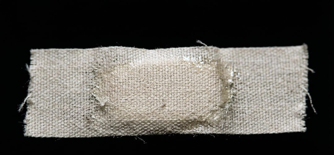 Closeup fabric adhesive bandage on black background
