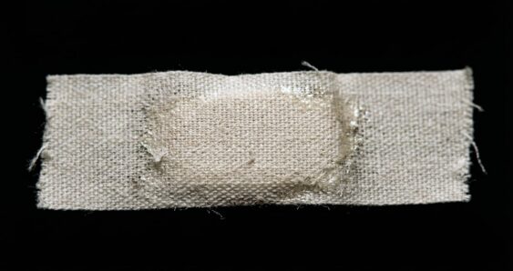 Closeup fabric adhesive bandage on black background