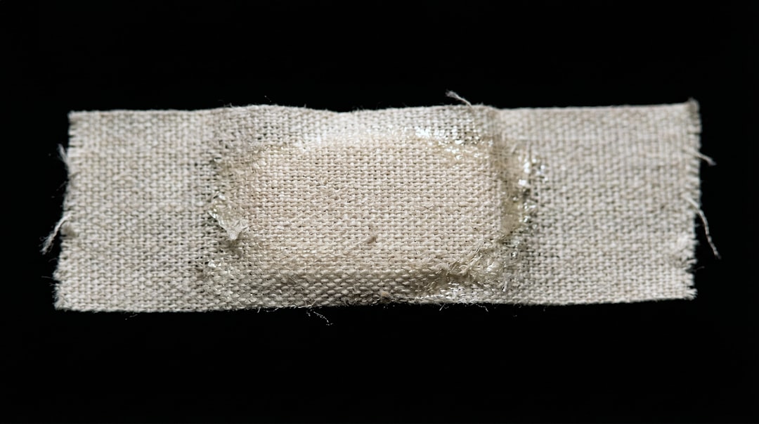 Closeup fabric adhesive bandage on black background