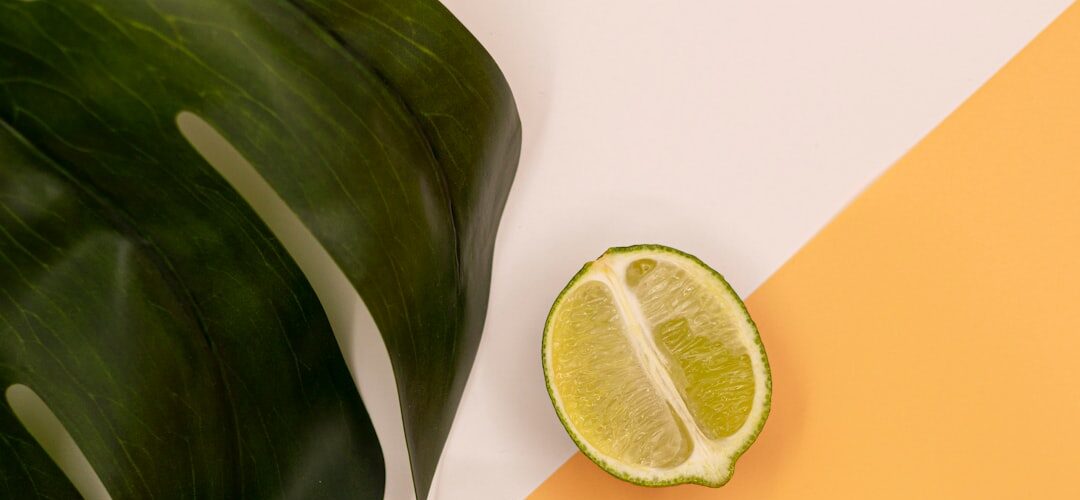 Two lime halves with large green leaf