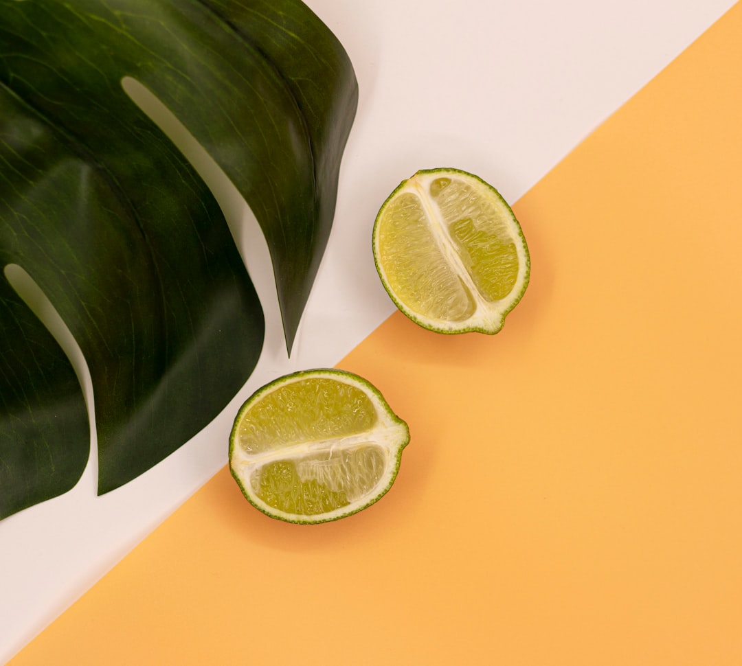 Two lime halves with large green leaf