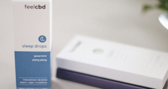 FeelCBD sleep drops box and vape pen on table