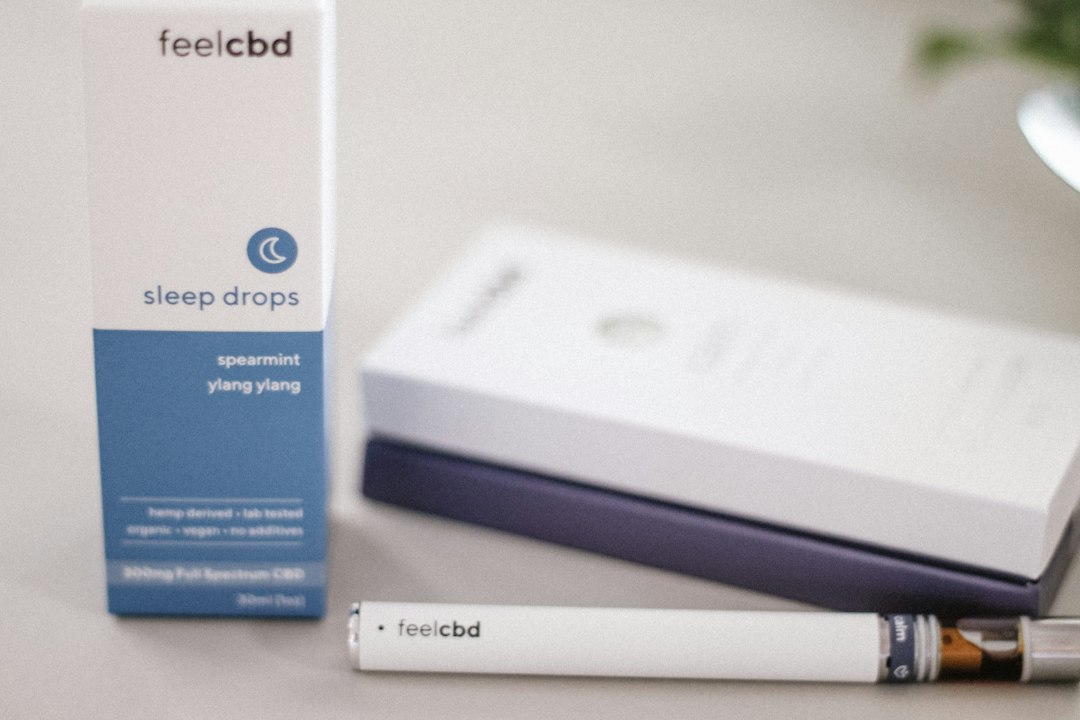 FeelCBD sleep drops box and vape pen on table